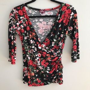 Salaam brand faux wrap shirt with floral print.